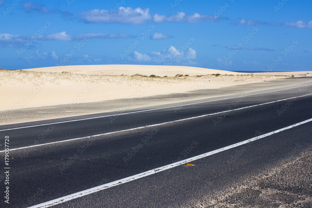 Coast asphalt road. Sunrise on asphalt coat, macro photo of road. Beach way. Highway in Spain. Coast asphalt road. Sunrise on asphalt coat, macro photo of road. Beach way. Highway in Spain.