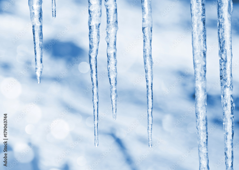 Background of bright transparent icicles in the sunlight