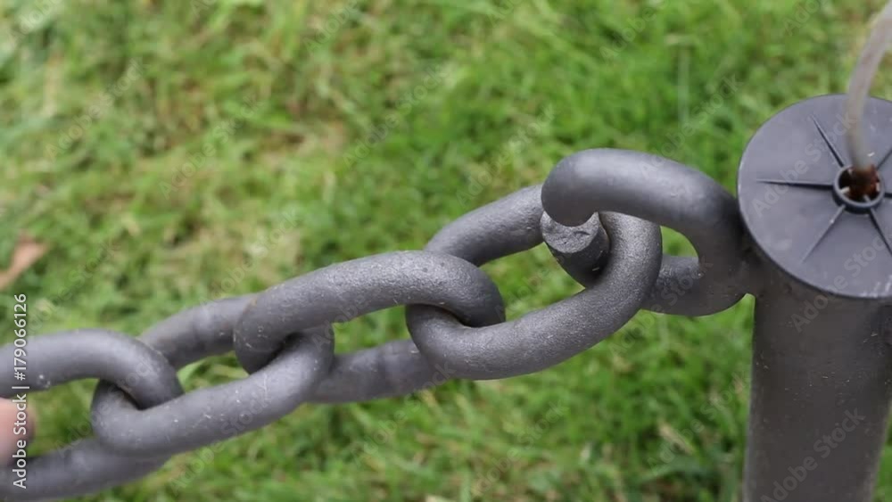 Hand man who closes a chain fence Hand man who closes a chain fence
