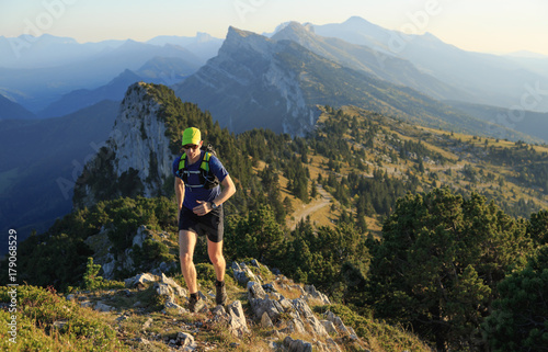 Man trailrunning in the mountains on a beautiful afternoon. Vercors, France. © sanderstock