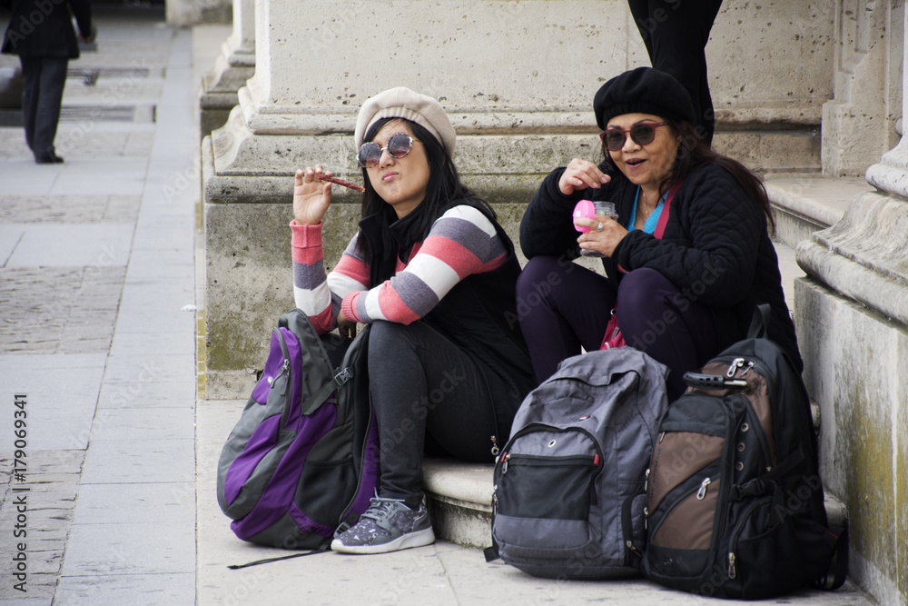 Asain thai women mother and daughter sit and eating food at Musee du Louvre