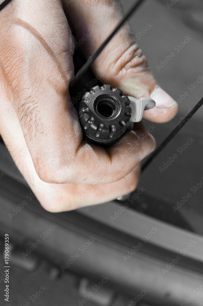 Vertical view of Man pumping bicycle tyre outdoors, close-up of hands