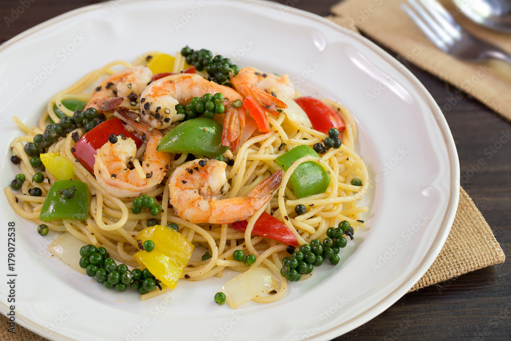 Spaghetti Prawns Stir Black pepper sauce Delicious Thai food in white dish on dark background / Select focus.