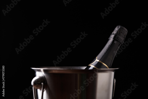 Image of bottle of wine in iron bucket