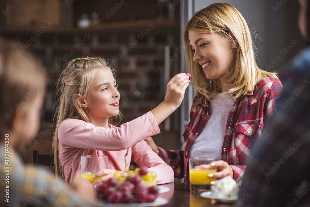mother and daughter having breakfast mother and daughter having breakfast
