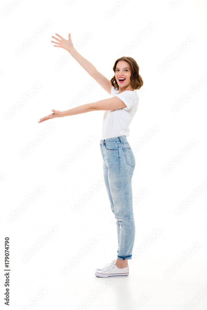 Cheerful pretty caucasian lady standing isolated showing copyspace. Cheerful pretty caucasian lady standing isolated showing copyspace.
