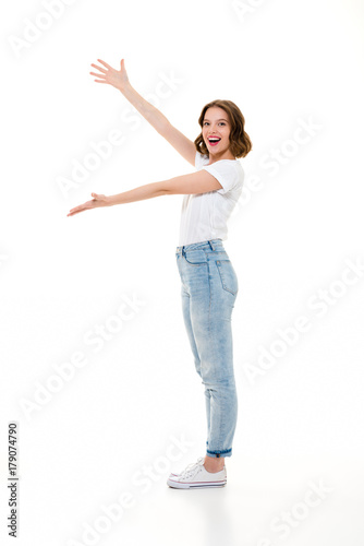 Cheerful pretty caucasian lady standing isolated showing copyspace.