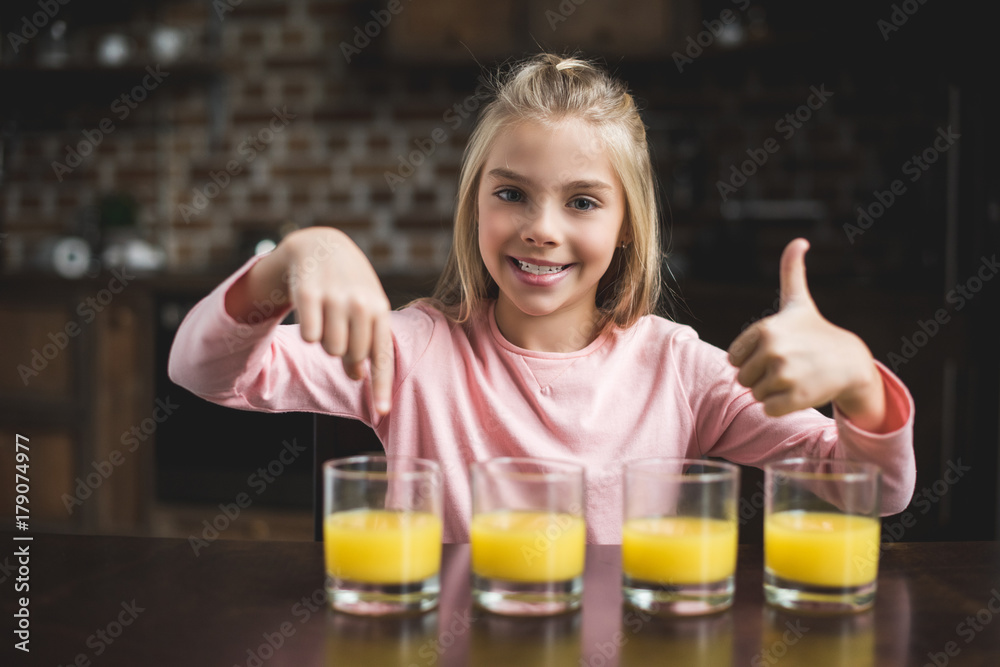 child with glasses of juice child with glasses of juice