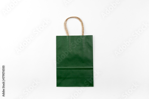 Dark green paper bag with handles on a white background top view