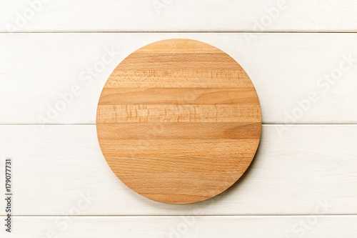Empty wooden cutting board on a white background, top view photo