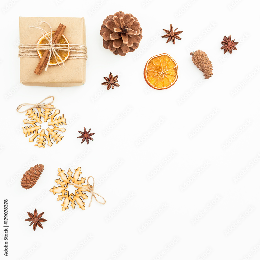 Christmas or New Year composition of decoration, craft gift box and pine cones on white background. Flat lay, top view