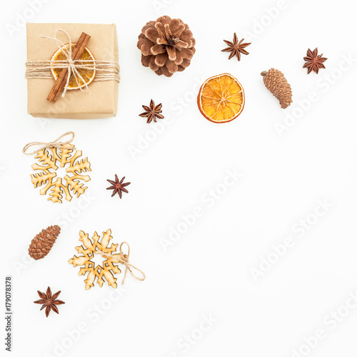 Christmas or New Year composition of decoration  craft gift box and pine cones on white background. Flat lay  top view