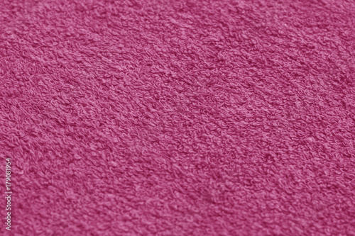Pink color towel surface close-up with blur effect.