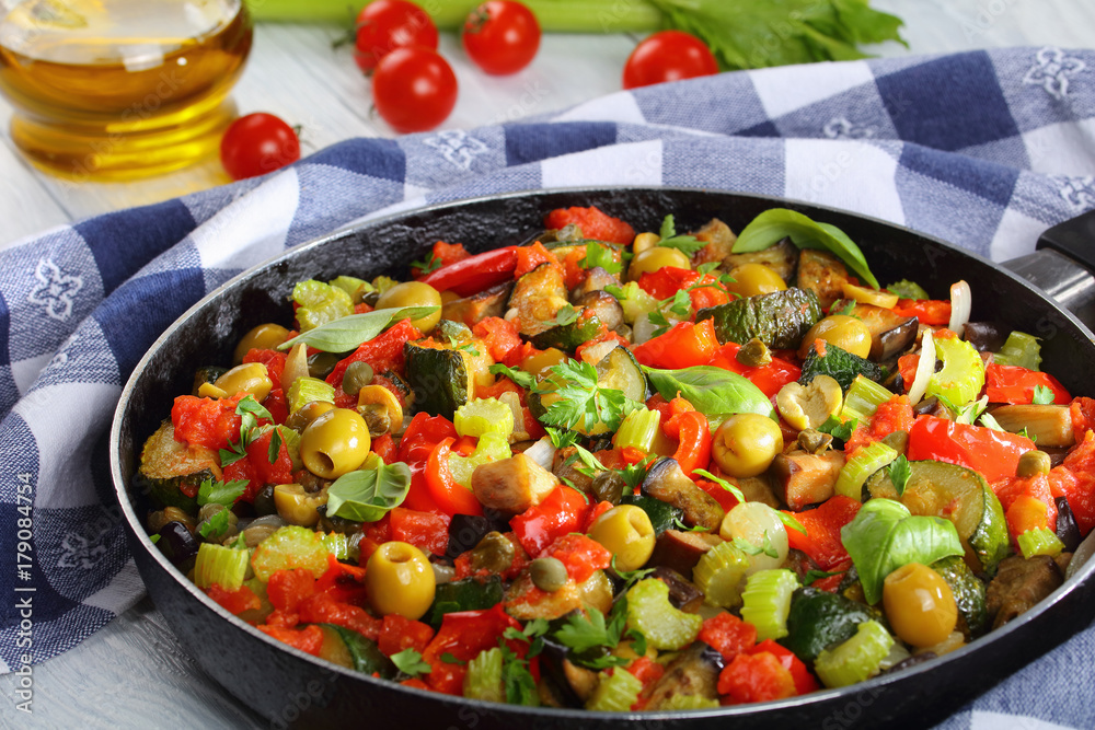 caponata with vegetables in a skillet caponata with vegetables in a skillet