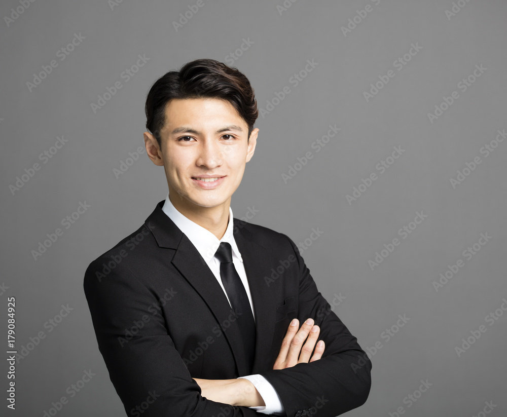 young smiling businessman with gray background young smiling businessman with gray background