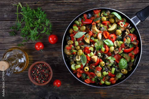 tasty Caponata with vegetables on skillet