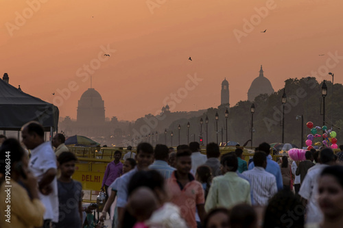 Crowd of people during sunset with government buildings in the background, New Delhi, India