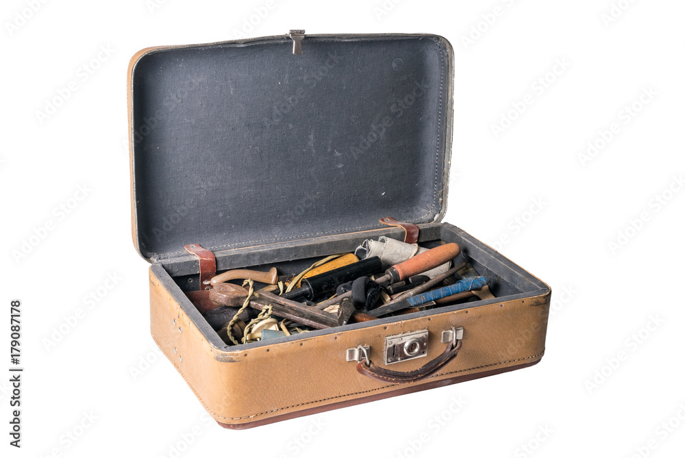 Open retro suitcase full of old working tools isolated on a white background Open retro suitcase full of old working tools isolated on a white background