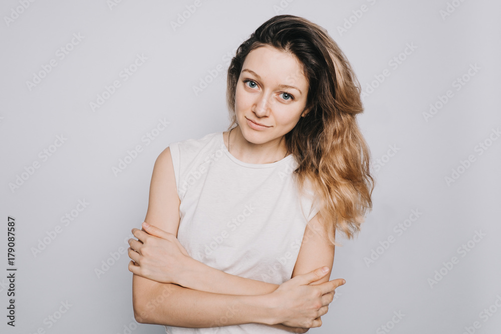 Young confident happy young Caucasian girl looking at camera on white background. Ambitious student Young confident happy young Caucasian girl looking at camera on white background. Ambitious student