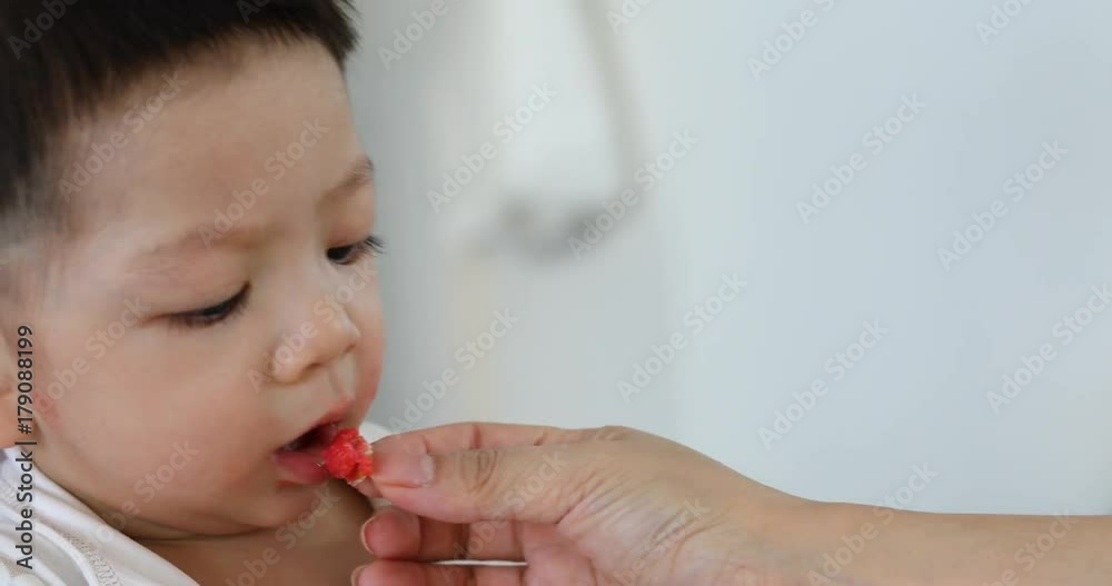cute baby boy happy eating food with mother cute baby boy happy eating food with mother