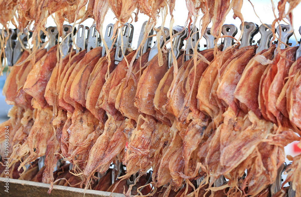 Dried squid hang on the line.