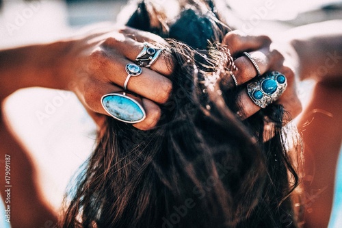 Close up of Women with bohemian style jewellery rings on hands photo