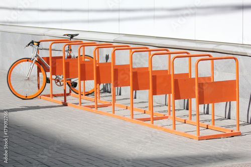 Orange bicycle stands on the orange bicycle park