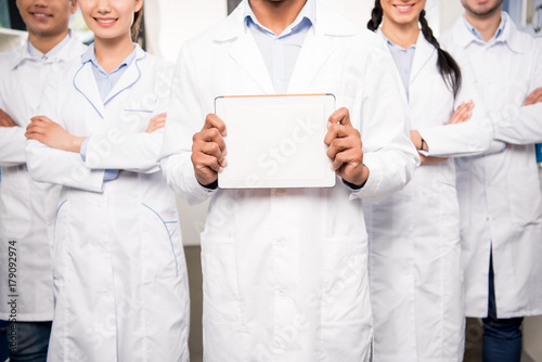 Team of doctors with blank card