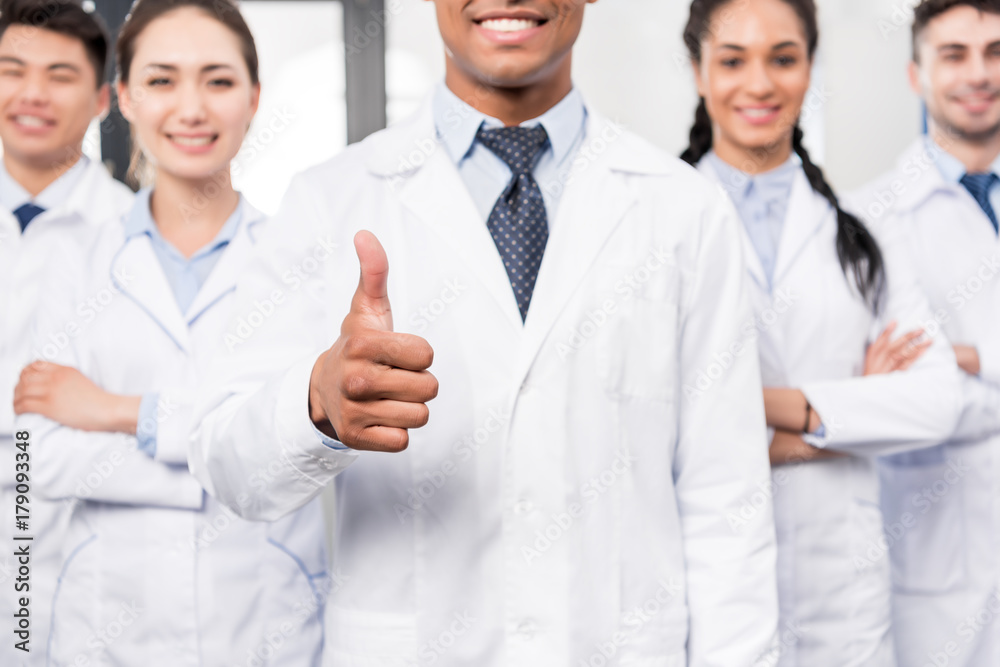 Doctor with team showing thumb up