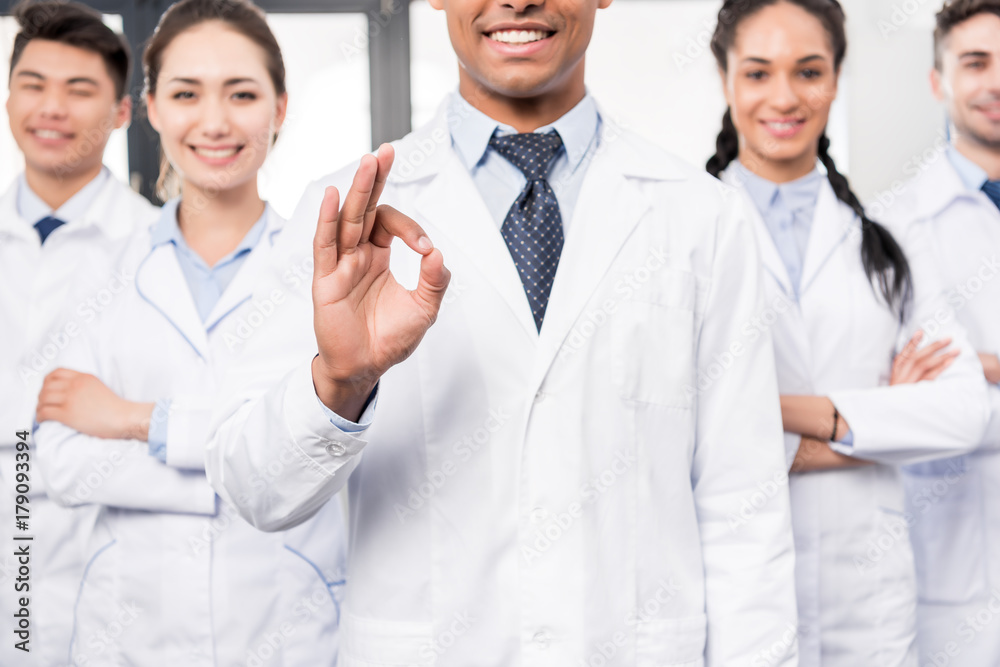 Doctor with team showing ok sign Doctor with team showing ok sign