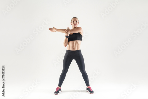 Young woman doing aerobic exercising and looking at camera