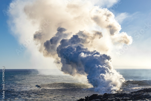 Eruption of a volcano on the Hawaiian island on the ocean. Volcanic activity. Tourism. Field of frozen black lava