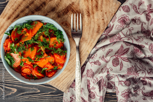 cooked fried pumpkin in a bowl on a wooden gray background texture photo