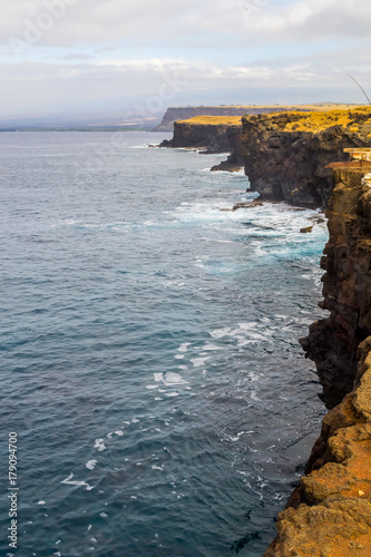 Stone shore of the island in Hawaii. Volcanic island photo