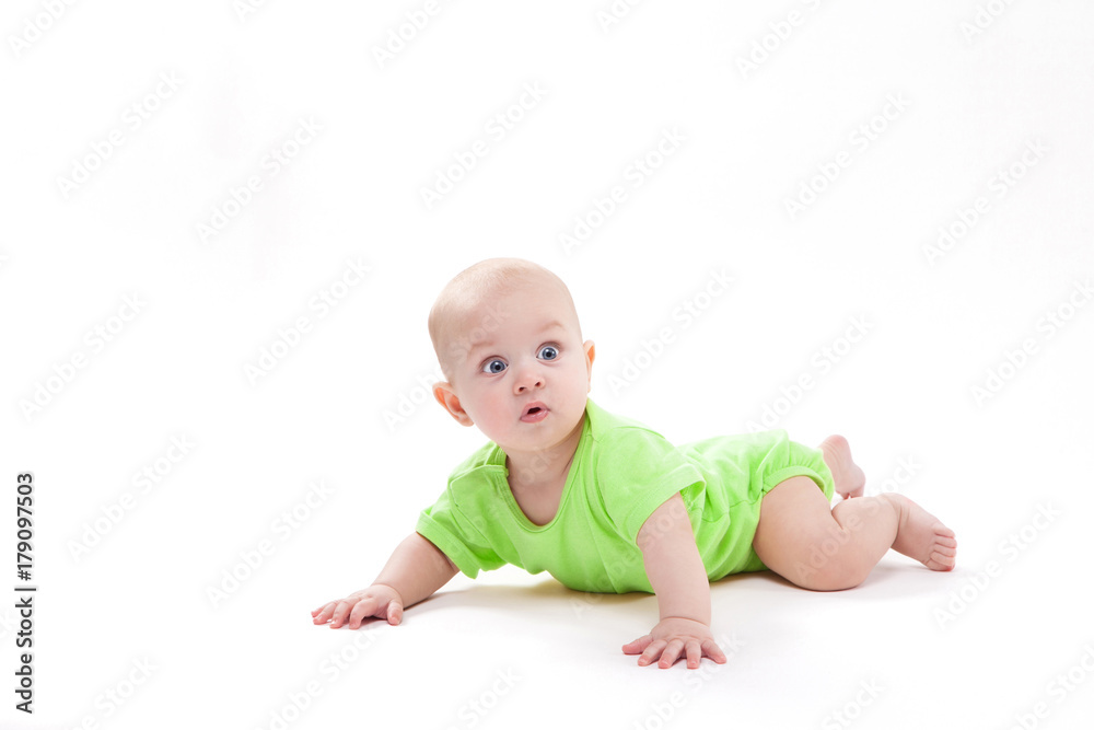 Surprised cute baby lying on his stomach and looking at the camera Surprised cute baby lying on his stomach and looking at the camera