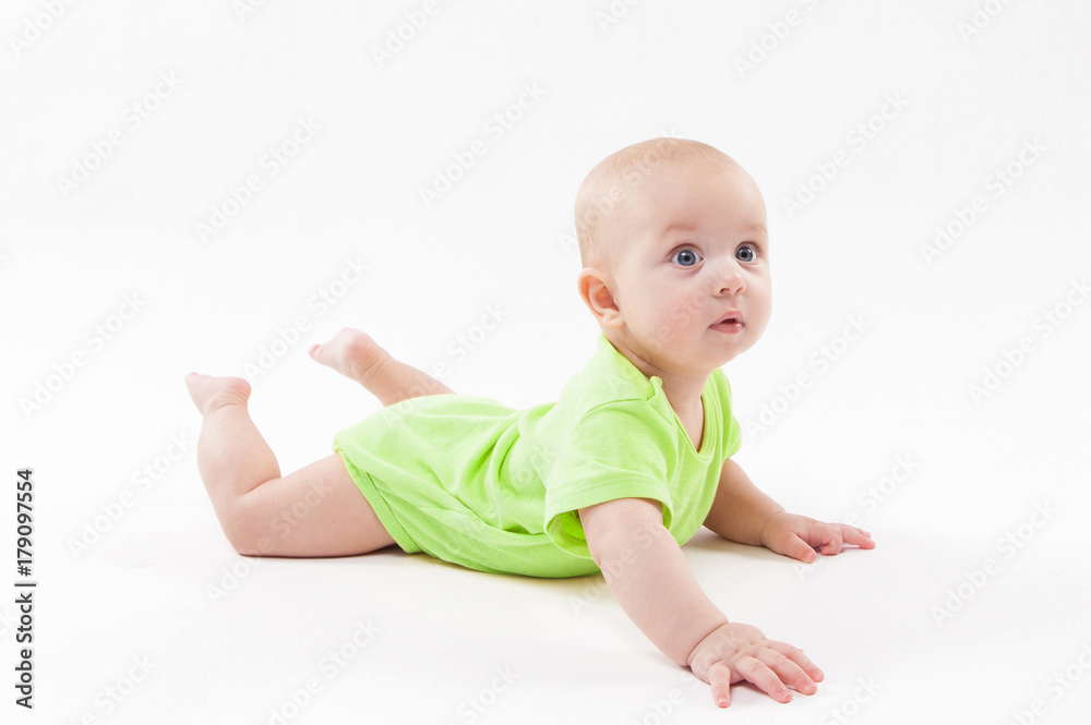 Surprised cute baby lying on his stomach and looking at the camera Surprised cute baby lying on his stomach and looking at the camera