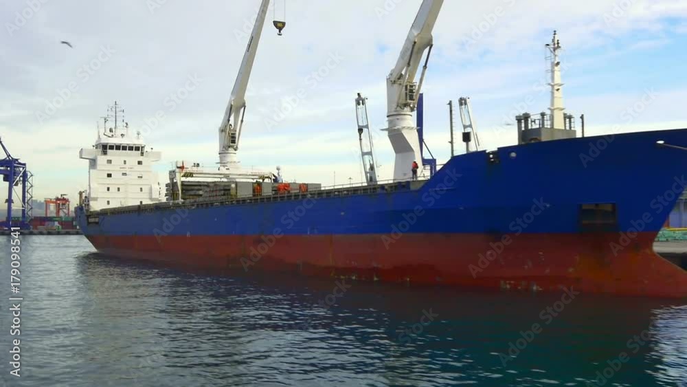 Freighter ship or cargo vessel under loading in Haydarpasa Container Port. HD pan shot from the waterside Freighter ship or cargo vessel under loading in Haydarpasa Container Port. HD pan shot from the waterside
