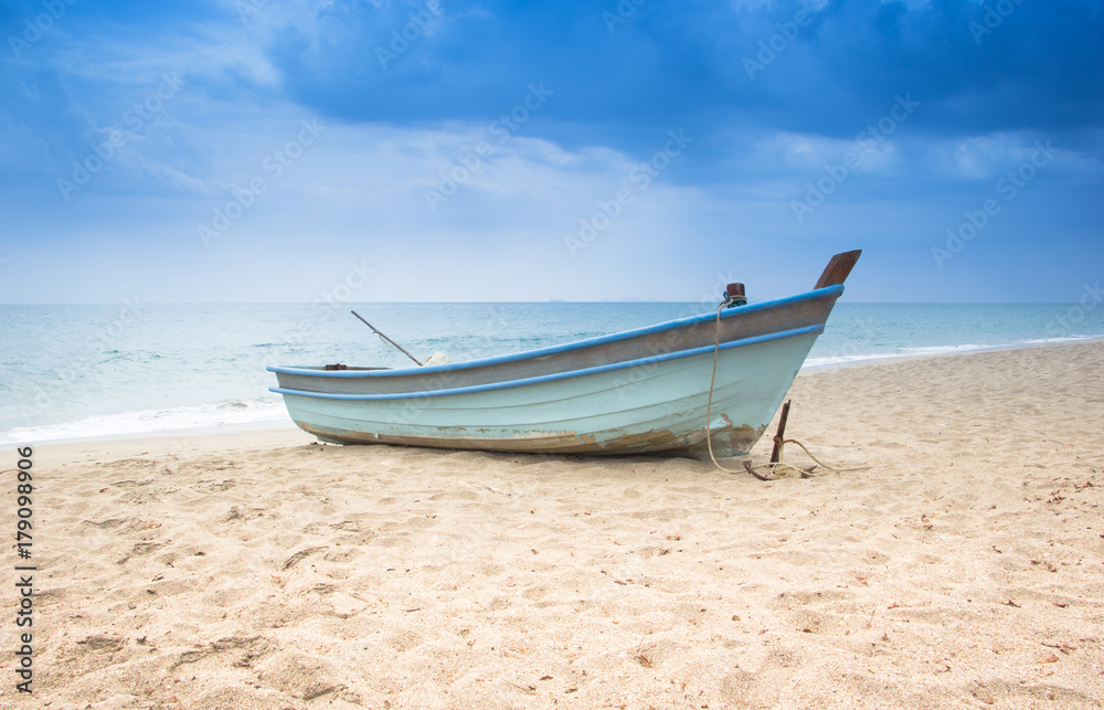 Little boat on the beach with the storm background