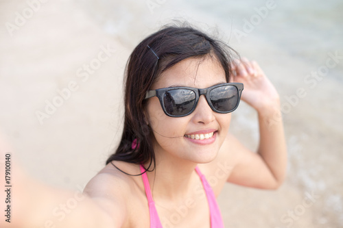 Portrait of Happy traveler Woman Selfie with at beach. Asian women using Smartphone with Happy emotions, Woman with Travel Concept.