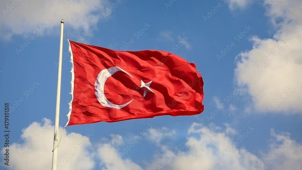 Turkish Flag waving in the wind over blue sky with white clouds. Slow Motion, Loop, HD 1080p video. The flag of Turkey; A red flag featuring a white star and crescent often called as moon-star (Ayyild