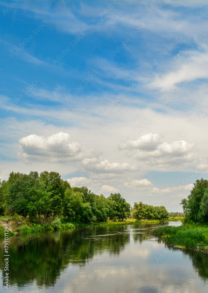 Gorgeous summer landscape - Ukrainian river, blue sky, clouds.