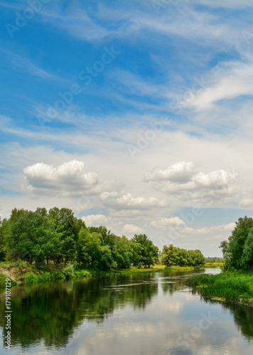 Gorgeous summer landscape - Ukrainian river, blue sky, clouds.