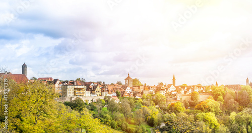 Europe culture concept - panoramic city skyline birds eye aerial view under dramatic sun and morning blue cloudy sky in Rothenburg, Germany