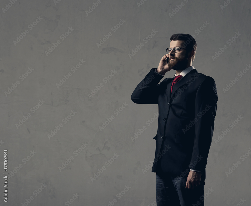 Businessman with smartphone standing over white wall. Business, office, concept. Businessman with smartphone standing over white wall. Business, office, concept.