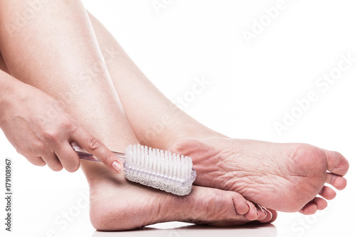 care for dry skin on the well-groomed feet and heels with the help of tools pedicure pumice and brush Foot