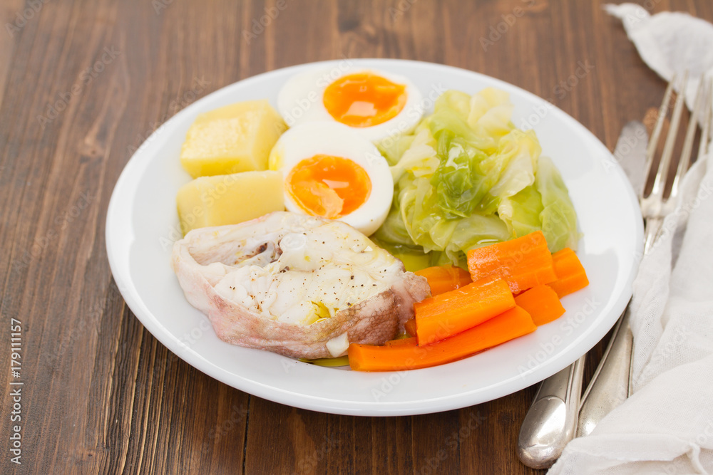boiled fish with boiled vegetables on white plate boiled fish with boiled vegetables on white plate