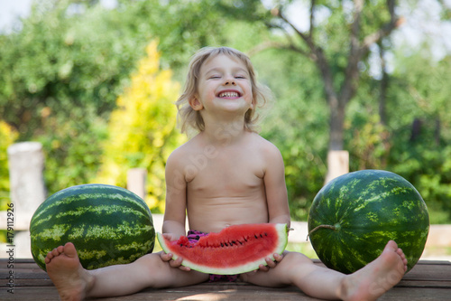 Funny little girl with watermelon slice photo