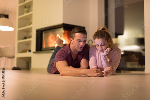 Young Couple using digital tablet on cold winter night