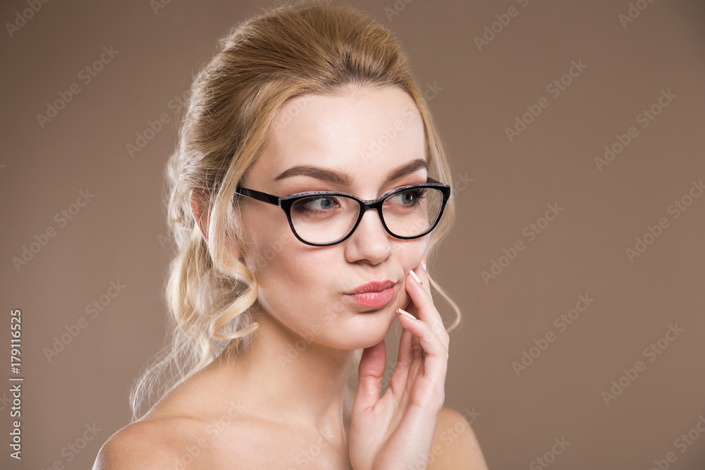 blond with hand near the lips blond with hand near the lips