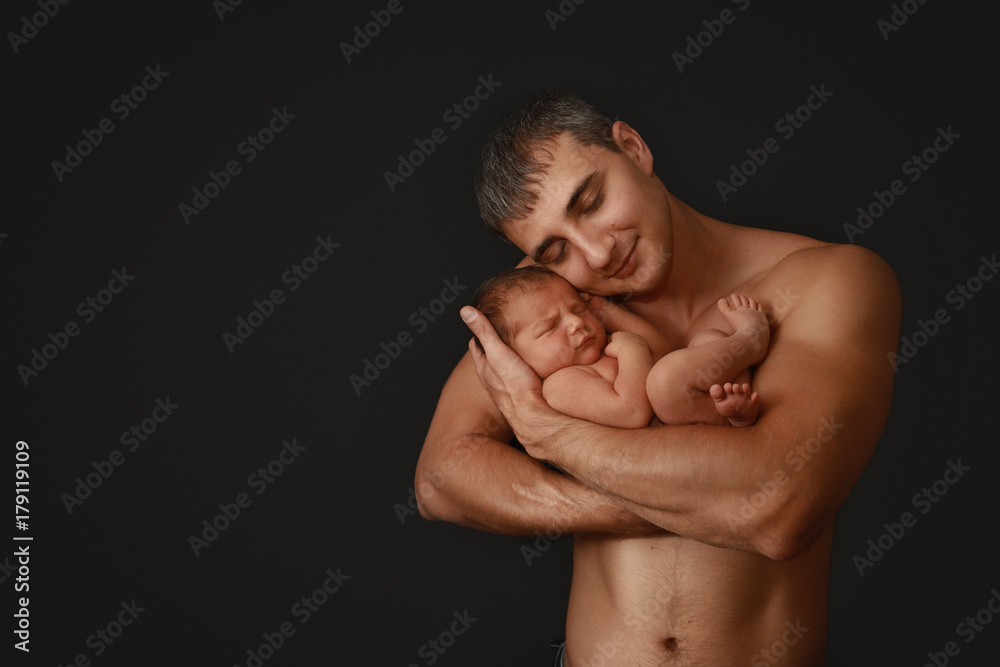 Newborn With Dad on Black Background